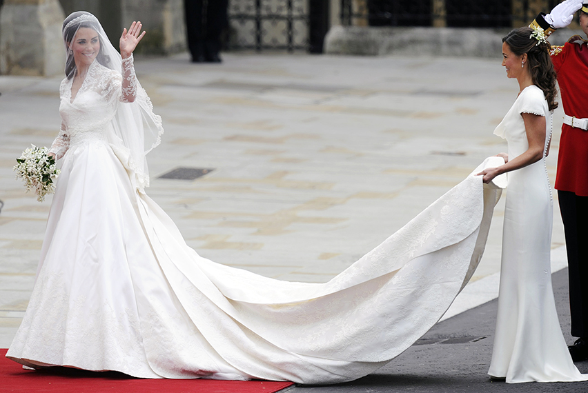 Kate Middleton waves as she arrives at t