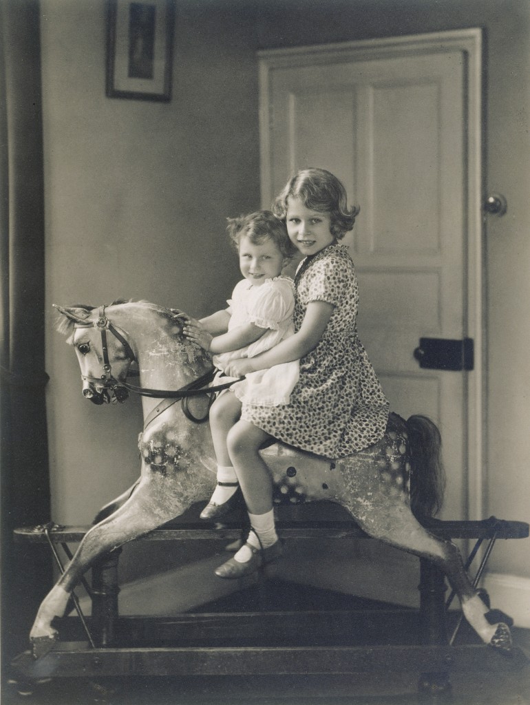 Princess Elizabeth and Princess Margaret on a rocking horse, August 1932 Royal Collection Trust / (C) Her Majesty Queen Elizabeth II 2014. The Summer Opening of the State Rooms at Buckingham Palace and the special exhibition 'Royal Childhood', 26 July - 28 September 2014. 