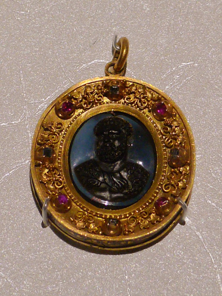 查理五世(Charles V)於西元1516年成為西班牙國王，之後在1519年獲得神聖羅馬帝國皇帝的稱號，統轄大半歐洲及西班牙在中南美洲的領土。此枚由瑪瑙、黃金、紅寶石、鑽石製作而成的浮雕寶石，可能是查理五世於1530年加冕時贈予教宗克雷芒七世(Clement VII)的禮物。加冕典禮象徵著神聖羅馬帝國與教廷間的和平，終結了長達四年的戰爭。